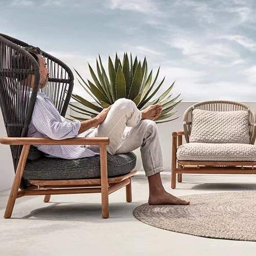Sofa constructed with a teak frame and weaved in round rope